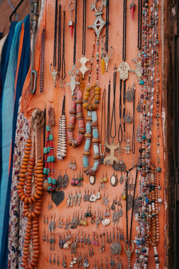 Vibrant collection of handmade necklaces and bracelets displayed on draped fabric, showcasing traditional craftsmanship.